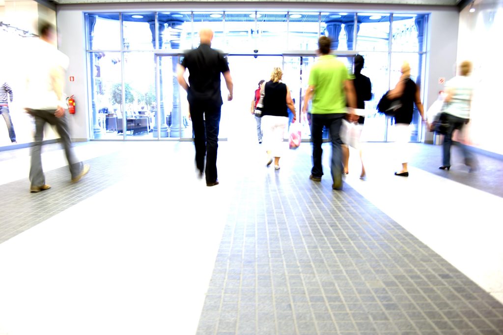 Shoppers exiting a busy mall